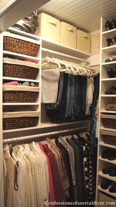 an organized closet with clothes, shoes and baskets on the shelves in front of it