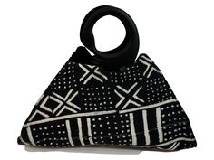 This Handmade Ghanaian Mud Cloth Purse Handbag showcases the unique beauty of Ghanaian mud cloth, while providing practicality and style with its spacious cotton interior, durable zipper enclosure, and one-of-a-kind handmade construction. The wooden handle, shaped like a sankofa bird, adds an authentic touch and highlights the traditional roots of this beautiful purse. Each bag is unique, so you can be sure that no one else will have the your chosen bag. Traditional Black Rectangular Bag, Traditional Black Rectangular Shoulder Bag, Traditional Black Handheld Bag, Traditional Black Tote Shoulder Bag, Traditional Black Pouch Bag, Traditional Black Bag For Everyday Use, Black Shoulder Bag For Market With Handles, Traditional Handmade Black Shoulder Bag, Artisan Black Bags With Leather Handles