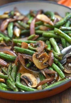 a bowl filled with green beans and mushrooms