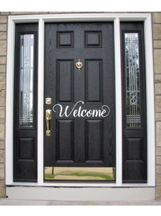 a black door with welcome written on it