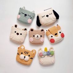 crocheted animal purses are arranged on a white surface