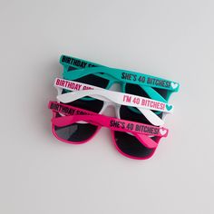 three pairs of sunglasses with the words birthday printed on them, sitting side by side