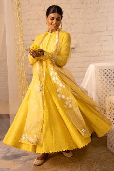 Lemon yellow organza jacket with floral embroidered motifs and front tassel tie-up. Paired with Chanderi sleeves, mukaish work anarkali and Chanderi pant, organza dupatta.
Component: 4
Embroidered
Neckline: Mandarin
Sleeve Length: Full
Fabric: Shantoon, Organza,Chanderi Mukaish, Chanderi
Color: Yellow
Gota, muskaish work
Striped pant
Tassel dupatta
Scallop border - Aza Fashions Bollywood Style Long Sleeve Sharara In Organza, Tissue Silk Anarkali Set With Sheer Dupatta, Traditional Long Sleeve Tissue Silk Dress, Festive Organza Anarkali Set With Chikankari Embroidery, Organza Churidar With Zari Work And Long Sleeves, Organza Anarkali Set With Gota Work In Traditional Drape, Long Sleeve Tissue Silk Salwar Kameez With Sheer Dupatta, Designer Long Sleeve Organza Churidar, Long Sleeve Tissue Silk Anarkali Set For Wedding