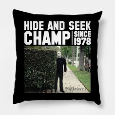 a black pillow with the words hide and seek champ printed on it, along with an image of a person wearing a mask