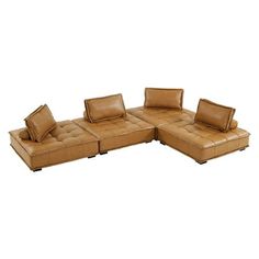 a brown leather sectional sofa with pillows on it's back and side facings