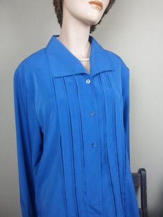 "This is a pretty blue \"Christie & Jill\" blouse from the 90's. It's a light-weight, sheer, long sleeve, polyester blouse with rows of inverted pleats on the button-down front. It's a very roomy, dressy blouse with fold-up two button cuffs. It has a straight cut hem line. It's still in new condition. The color could be described as a dark aqua blue.  It has shoulder pads (just snip to remove). Tag: \"Christie & Jill, Size Large\",100% polyester. Machine wash cold/line dry Please check measureme Pink Long Sleeve Dress, Turquoise Blouse, Dark Aqua, Polyester Blouse, Spring Blouses, Dressy Blouse, Vintage Turquoise, Button Down Blouse, Blue Long Sleeve