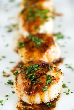 seared scallops with brown sauce and parsley