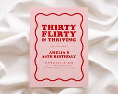 a pink birthday card with the words thirty flirty and thriving written in red on it