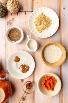 several different types of food are on the table with utensils and spoons