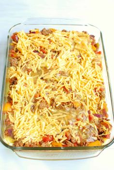 a casserole dish with cheese and meat in it on a white counter top