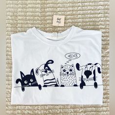 Pixie Lady Dogs And Cats Long Sleeved White Black Tshirt Size L Nwt Underarm To Underarm Lying Flat: 23” Sleeve: 22.5” Length: 25.5” **Smoke Free** Playful Crew Neck T-shirt With Cat Design, Playful Cat Design Crew Neck T-shirt, Cute White Tops With Cat Design, Playful Cotton T-shirt With Cat Print, Playful Cotton Cat Print T-shirt, White Crew Neck Top With Cat Design, White Crew Neck Top With Dog Print, Cute White Tops With Dog Print, White Cotton Top With Dog Print