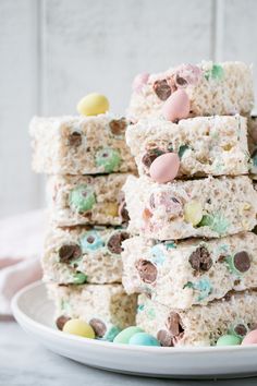 some rice krispy treats are stacked on top of each other in front of an easter egg