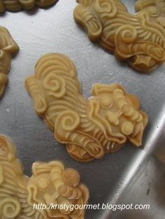 some cookies that are shaped like animals on a cookie sheet in the shape of lions