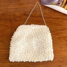 1960s Mr. Ernest Simon white sequin and bead evening handbag with white satin interior, gold hardware and an elegant chain top handle in excellent condition. 6" by 6" with a 5" drop chain. Very nice vintage condition. Great Gift! White Evening Bag With Pearl Embroidery For Party, Vintage White Clutch For Party, Vintage White Party Bags, White Vintage Party Bag, White Embellished Evening Bag, Vintage White Embellished Evening Bag, Glamorous White Beaded Evening Bag, Vintage White Evening Bag For Events, White Sequin Party Bag