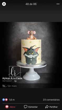 a cake with an image of a cat and mouse on it