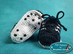 two crocheted baby shoes with black and white polka dots