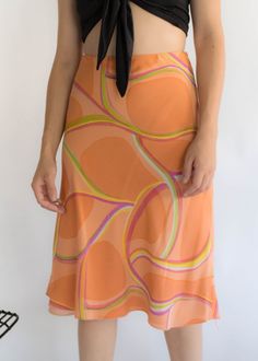 "Vintage 90s abstract silk skirt. Brightly colored abstract silk skirt perfect for the Spring / Summer season! Low-waisted fit. Flowy a-line silhouette. Below knee length. Side hook and eye and zipper fastening. Fully lined. We kindly ask that you please view all measurements for comparison so you can get your desired fit. Made in New York. * Brand: Lafayette New York 148 * Decade: 1990s * Fabric: Silk * Lining: Polyester Crepe * Color: Orange, Lime Green, Pink C O N D I T I O N Excellent vintag Fitted Skirt With Retro Print For Spring, Spring Silk Draped Skirt, Spring Asymmetrical Silk Skirt, Multicolor Silk Flowy Skirt, Summer Flowy Skirt With Abstract Print, Lafayette New York, Chic Pre-draped Asymmetrical Silk Skirt, Low Waisted, Silk Skirt