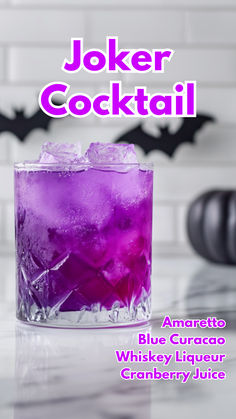 a purple drink in a glass with the words joker cocktail