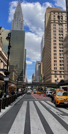 an empty city street with tall buildings in the background