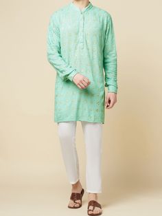 This Mint Green Lucknowi Embroidered kurta will instantly give an elegant look. Made from polyester cotton fabric, this 2 piece kurta set features a mint green lucknowi kurta, front buttons fastening, designer cuff buttons, and a mandarin collar. This mint green kurta has beautiful sequins Jaal thread embroidery work all over. It is paired with white churidar pants. An ideal outfit for traditional & special events.

Size Chart For Men





	
	
					Men's Size Chart
		

		
		
						
				Size Char Lucknowi Kurta, White Churidar, Kurta Set For Men, Rohit Bal, Thread Embroidery, Churidar, Kurta Set, Green Cotton, Mandarin Collar