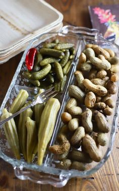 two trays filled with pickles and peanuts