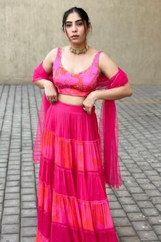 Pink and red attached cancan tiered panelled lehenga with floral print. Paired with a floral print padded blouse and net dupatta with chinta work on the dupatta. - Aza Fashions Festive Dresses With Ruffled Skirt, Fitted Lehenga With Dupatta And Tiered Skirt, Summer Fitted Choli With Ruffles, Fitted Sleeveless Ruffle Choli, Traditional Festival Lehenga With Tiered Skirt, Tiered Ruffle Georgette Lehenga, Floral Ruffle Lehenga, Floor-length Pink Lehenga With Ruffles, Red Ruffled Sleeveless Sets