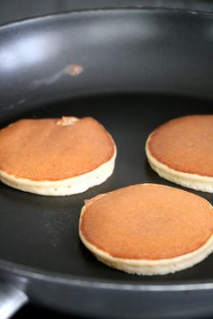 three pancakes are being cooked in a pan