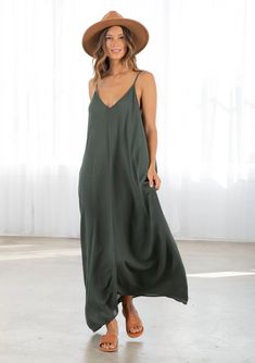 Dark Green Colored Tank Top style Maxi Dress. With pockets attached Unlined V-neck Maxi Dress For Beach, Chic V-neck Rayon Maxi Dress, V-neck Slip Dress For Summer Loungewear, Casual V-neck Maxi Dress For Date Night, Chic Solid Color Slip Dress For The Beach, Chic Slip Dress For The Beach, V-neck Maxi Sundress For Day Out, Flowy Maxi Dress Unlined, Unlined Flowy Maxi Dress