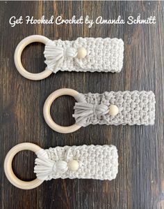 two crocheted hooks with wooden handles on a table