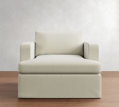 a white couch sitting on top of a wooden floor