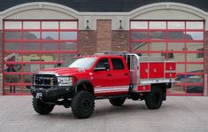 a large red truck parked in front of a building