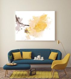 a living room filled with furniture and a painting on the wall above it's couch