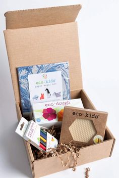 an open cardboard box containing eco - kids's products on a white background,