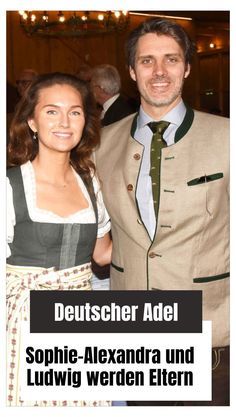 a man and woman standing next to each other in front of a poster with the words deutscher adel