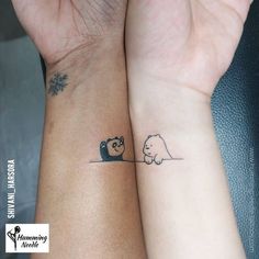 two people with matching tattoos on their wrists, one holding the other's hand