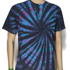 a black and purple tie - dyed shirt with green accents on the chest, sitting on a mannequin's head