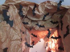 bats are flying in the air over a bed sheeted with brown and black paper