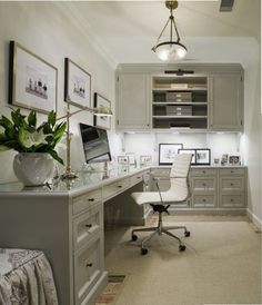 a home office with gray cabinets and white furniture