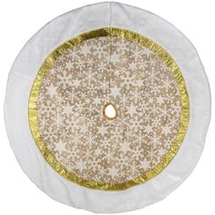 a white and gold round tablecloth with snowflakes on the edges, in front of a white background