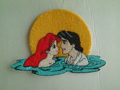 a couple kissing in the water with a yellow circle behind them that says, i love you