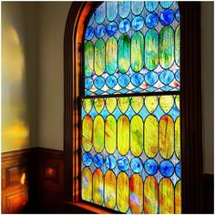 a stained glass window in the corner of a room