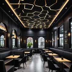 an empty restaurant with black booths and wooden tables