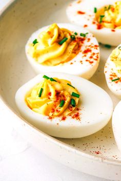 deviled eggs with mayonnaise and chives in a white bowl