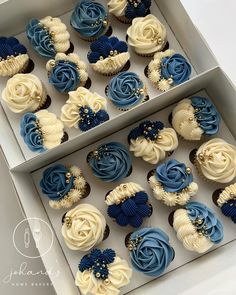 blue and white cupcakes are in a box