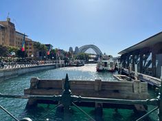 a boat is going down the river in front of a bridge and some buildings on both sides