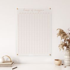 a white wall with a sign that says kings and queens on it next to a potted plant