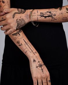 a woman's arm with tattoos on it