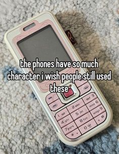 a pink cell phone sitting on top of a carpet next to the words, the phones have so much character i wish people still used these