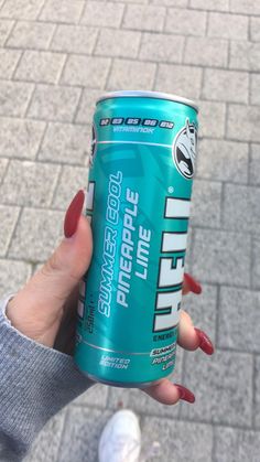 a woman holding up a can of energy drink