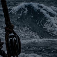 a boat in the ocean with large waves